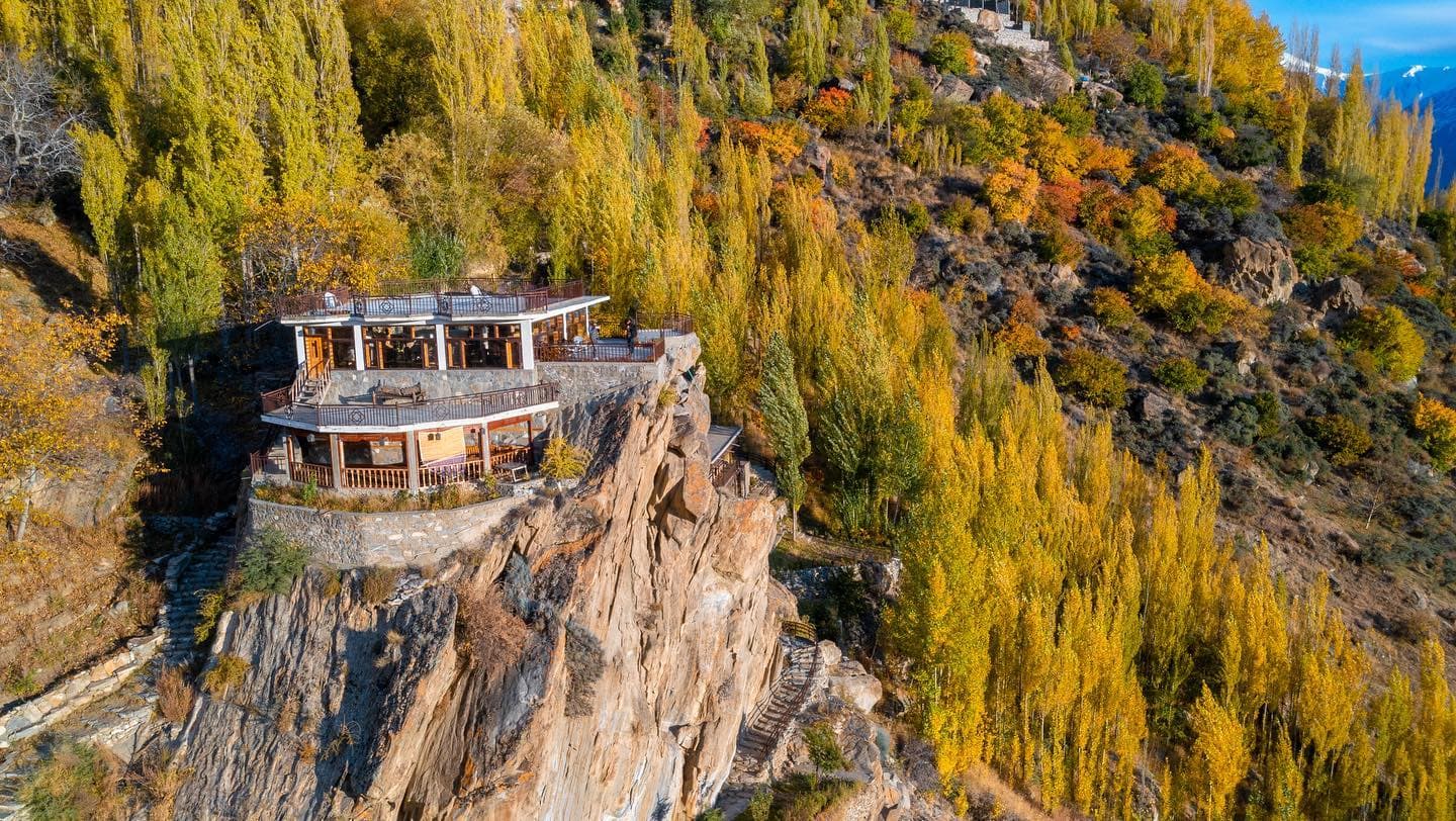 Offsite cliffside property surrounded by autumn trees
